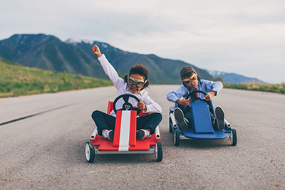 Two children racing on go karts