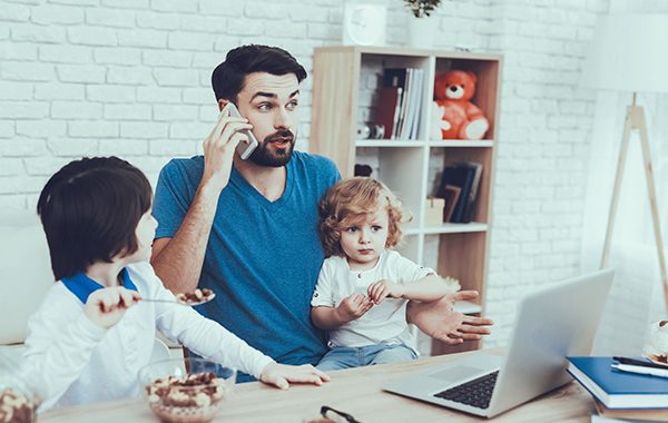 man working from home with children